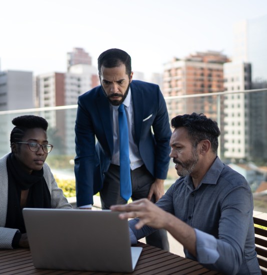 Coworkers dicussing project during a meeting outdoors