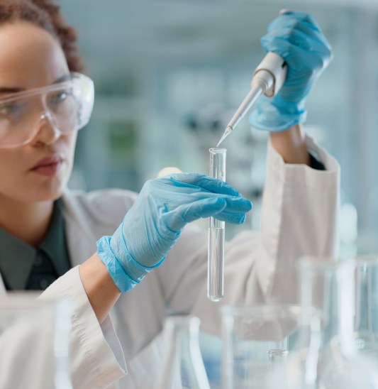 Scientist, woman and test tube for research, laboratory or medical doctor in healthcare. Microbiology, innovation or life extension drug experiment, micro pipette and science with chemistry in clinic